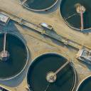 Could adopting industrial waste as a resource for wastewater purification establish a sustainable economic model for power-intensive industries?